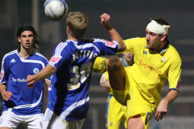 Bandaged-up PNE striker Chris Brown challenges for the ball at Peterborough