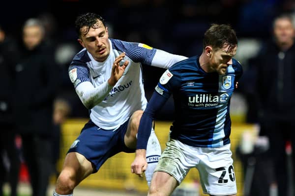 Preston North End’s Josh Earl challenges Huddersfield defender Ollie Turton