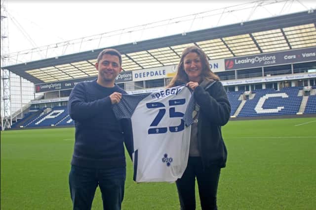 Jonny and Rachel at PNE with the shirt they will be taking on a 500-mile trek in memory of Sam Pegram. (Image: PNE Community and Education Trust).