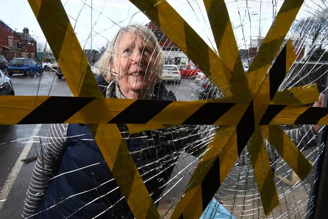 Volunteer Suzanne Wharton inspects the damage at  Barnardo's store and donation centre on Blackpool Road  Photo: Neil Cross