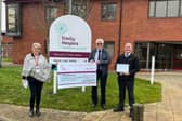 Nigel Dunnington centre hands over the money raised to Trinity Hospice