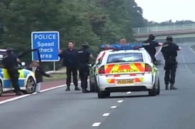 Armed police make an arrest on the M6