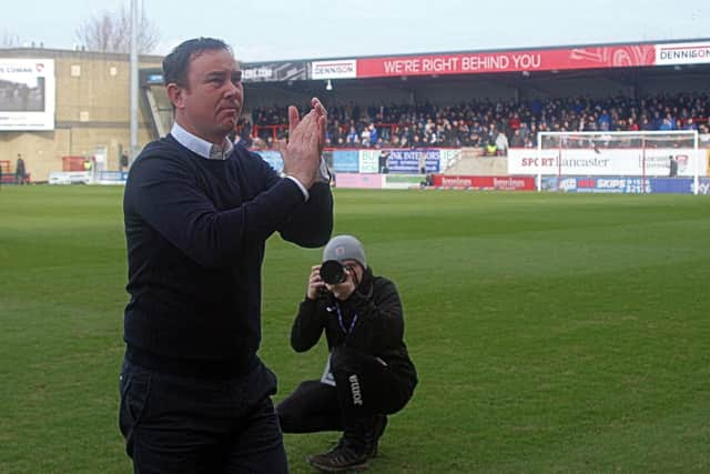 Morecambe boss Derek Adams applauds the fans before kick-off at the weekend