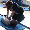 One student mastering first aid.