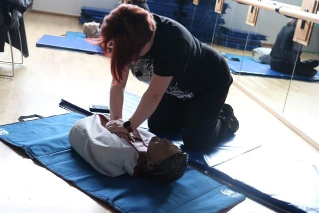 One student mastering first aid.