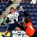 Preston North End striker Lee Ashcroft lifts a shot over Brentford goalkeeper Kevin Dearden at Deepdale in October 1997