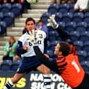 Preston North End striker Lee Ashcroft lifts a shot over Brentford goalkeeper Kevin Dearden at Deepdale in October 1997