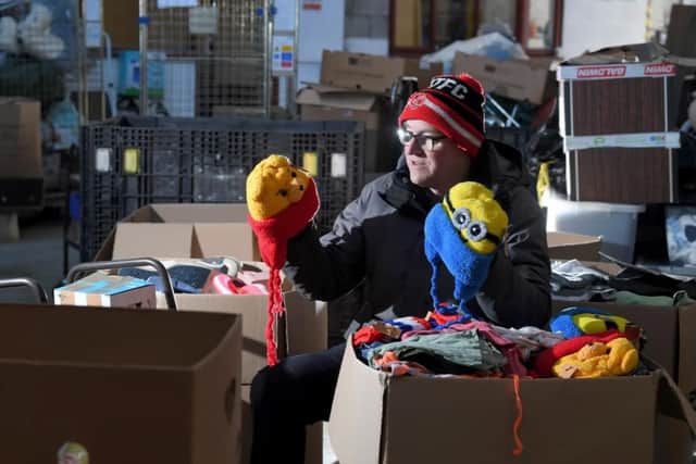 John Irwin sorting out children's woolly hats bound for Ukrainian refugee children.
