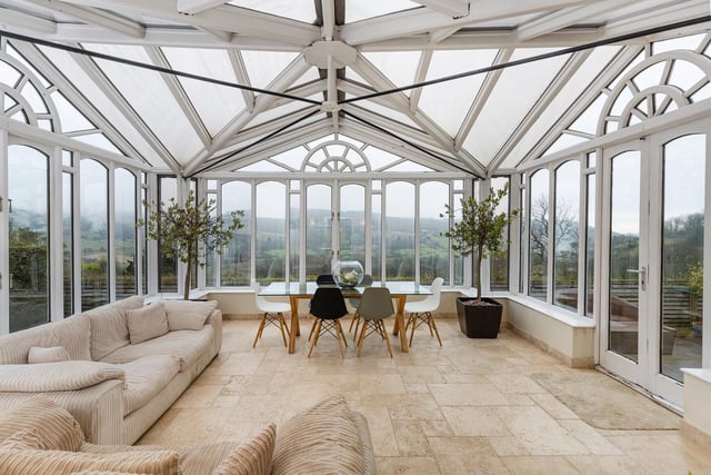 The spacious orangery has clear views out over the Shibden Valley, with doors out to a patio area.