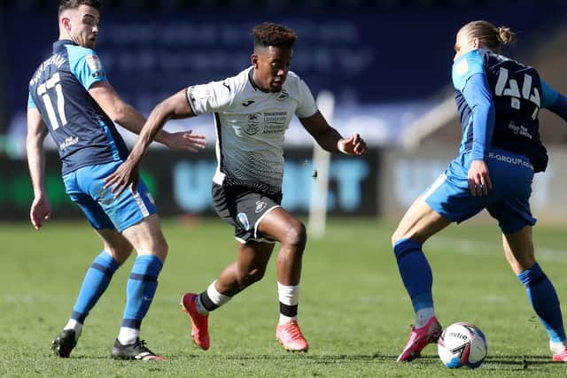 Swansea City's Jamal Lowe (centre) battles for the ball with Preston North End's Ben Whiteman (left) and Brad Potts (right)