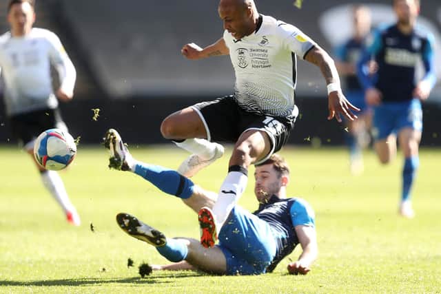 North End midfielder Ben Whiteman slide tackles Andre Ayew