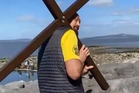 Tyson Fury carries a wooden cross along Morecambe prom on Good Friday.