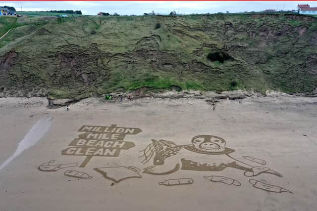 Aerial views of a 50-metre sand drawing created by Sand In Your Eye for Surfers Against Sewage's new Million Mile Beach Clean campaign, on Cayton Bay in Yorkshire