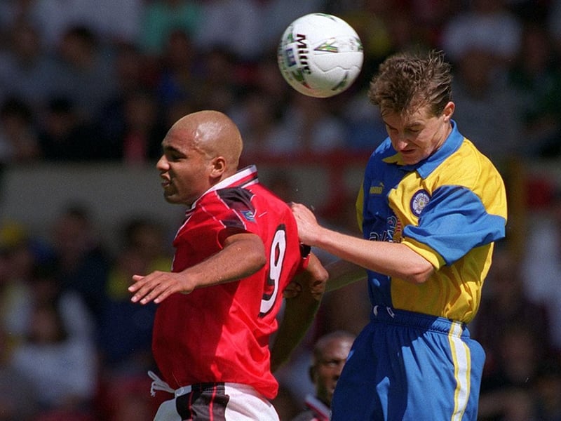 David Wetherall jumps to it with Nottingham Forest's Pierre van Hooijdonk during a pre-season friendly at the City Ground in August 1997.