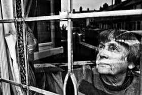 A powerful image of a woman glancing from a window in this Blackpool student's photograph. Photo by: Sammy Hall.