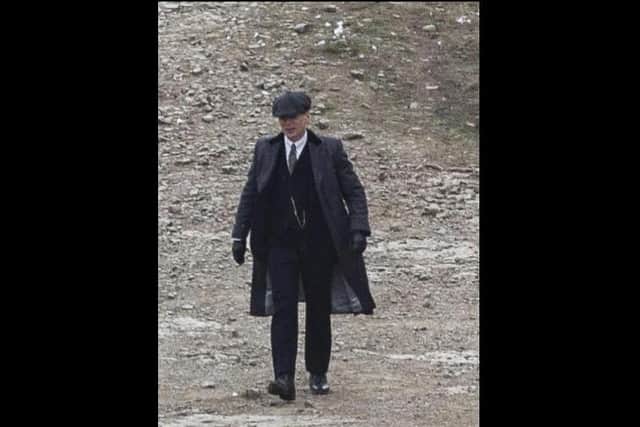 Cillian Murphy, who plays main character Tommy Shelby, was spotted strutting  around Lee Quarry in Bacup in his iconic tweed suit, heavy wool dark coats, penny collar shirt and his famous peaked cap during filming this week