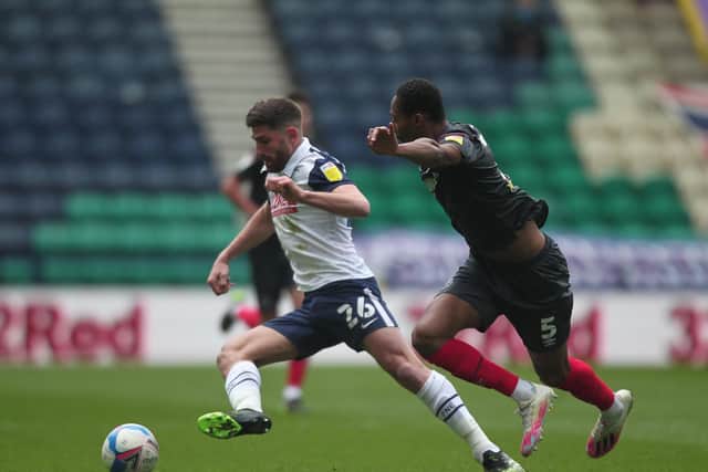 PNE striker Ched Evans is chased by Brentford centre-half Ethan Pinnock