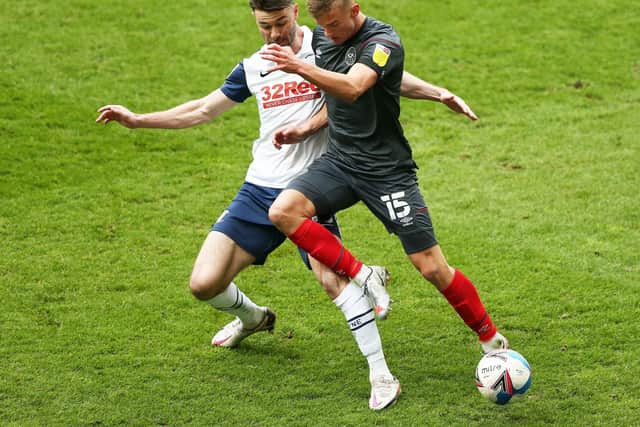 North End defender Andrew Hughes challenges Brentford's Marcus Forss