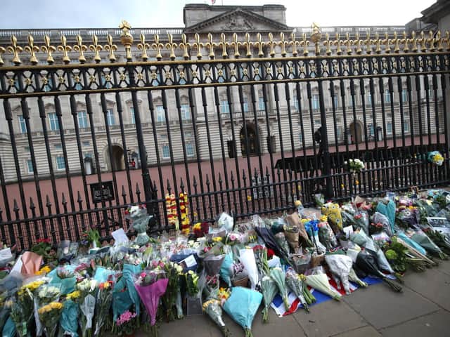 Floral tributes are left outside Buckingham Palace, following the announcement of the death of the Duke of Edinburgh at the age of 99. Picture date: Friday April 9, 2021. Picture: PA Wire/PA Images/Yui Mok