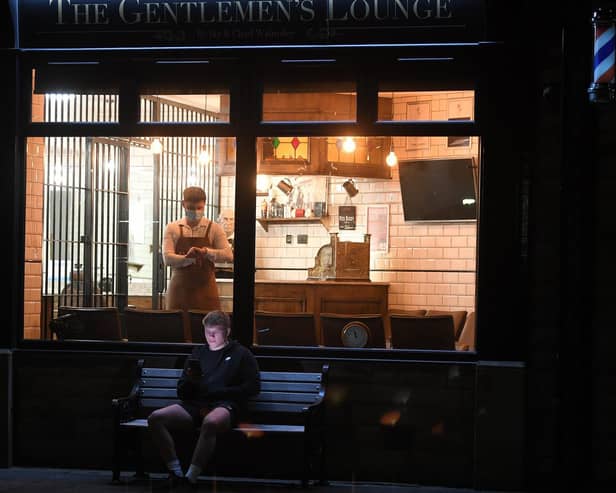Waiting for midnight - first customer Cam Wilkinson pictured outside The Gentlemen's Lounge, Longridge  waiting for barber Ike Walmsley to open for business.  Photo: Neil Cross
