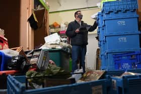 Graham Strong sorts through donations at Barnardo's Charity Shop at Ashton