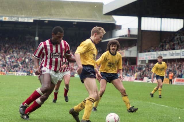 Preston North End's Lee Cartwright shields the ball against Stoke at the Victoria Ground, watched by Steve Harper