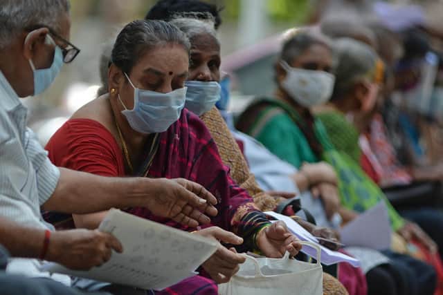 People wait for their turn to receive the Covid-19 coronavirus vaccine at a government hospital in Chennai  (Photo by ARUN SANKAR/AFP via Getty Images)