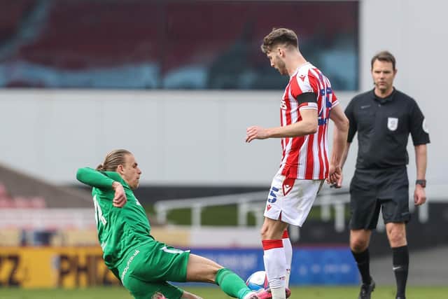 North Ened substitute Brad Potts slides in with a challenge on Stoke's Nick Powell