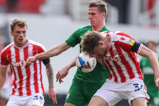 PNE striker Emil Riis battles for possession against Stoke