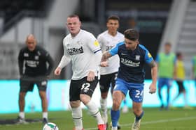Wayne Rooney is tracked by Sean Maguire in Preston North End's victory over Derby in the Carabao Cup in September