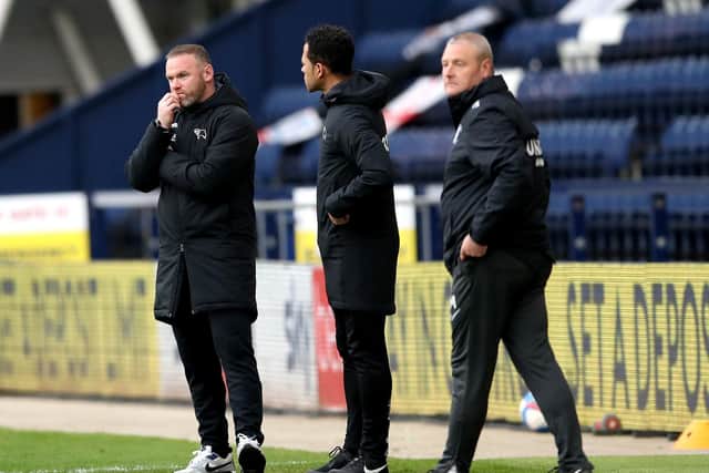 PNE interim head coach Frankie McAvoy in the technical area together with Derby's Wayne Rooney and Liam Rosenior