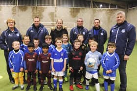 Sir Tom Finney Soccer Centre co-founders Kath Mason (far left) and Peter Mason (far right) with young footballers and coaches