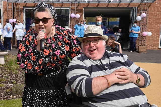 Singer Dani Wallace and her dad Danny Gallagher, a Sue Ryder centre resident, were reunited at the birthday party Photo: Neil Cross