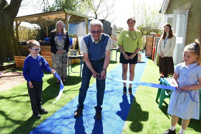 Roy Butterworth cuts the ribbon with Stanley and Isla, photo: Neil Cross.