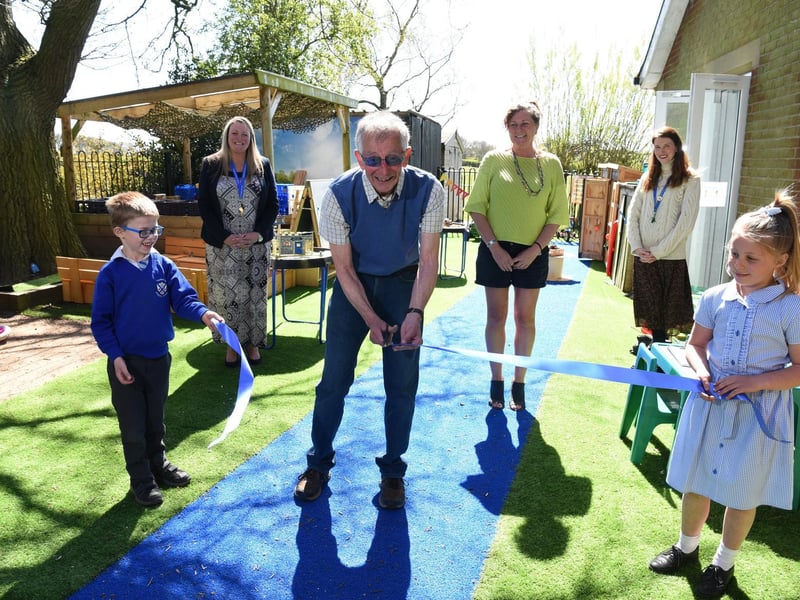 Roy Butterworth cuts the ribbon with Stanley and Isla, photo: Neil Cross.