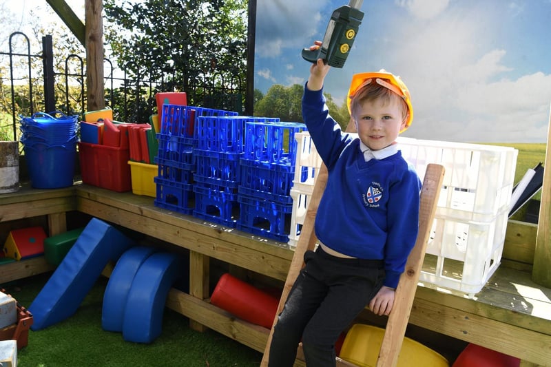 Archie dresses up as a builder in the improved outdoor area, photo: Neil Cross.