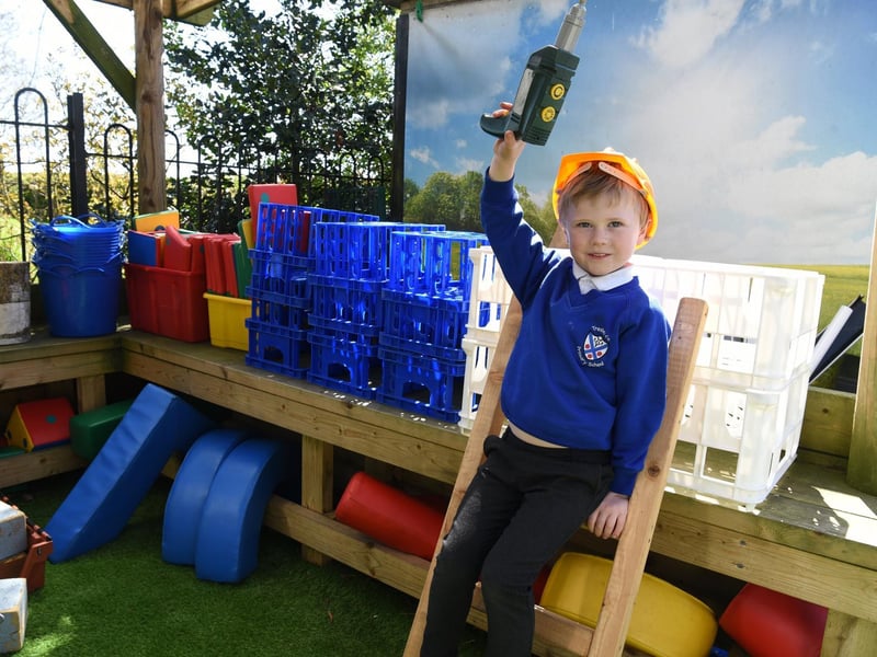 Archie dresses up as a builder in the improved outdoor area, photo: Neil Cross.