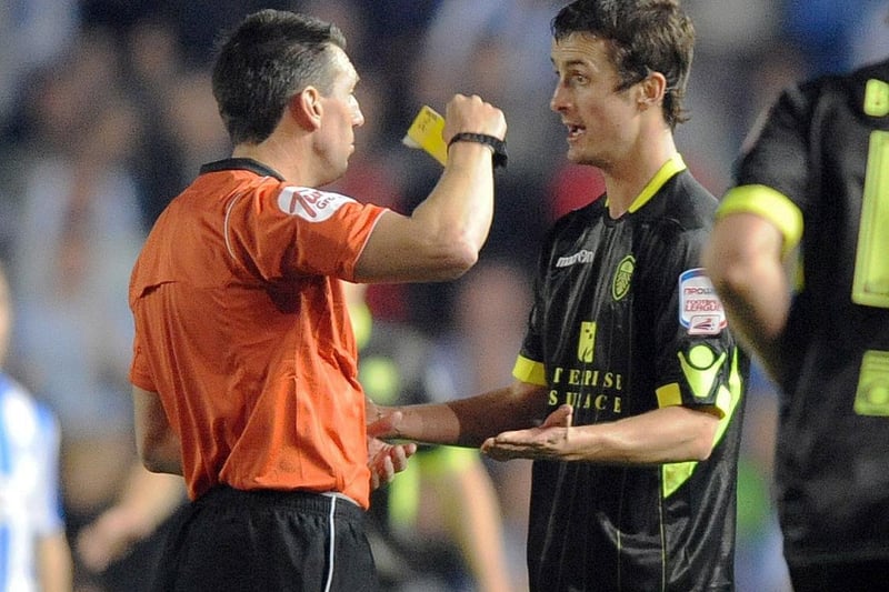 Danny Pugh is shown a yellow card by the referee.