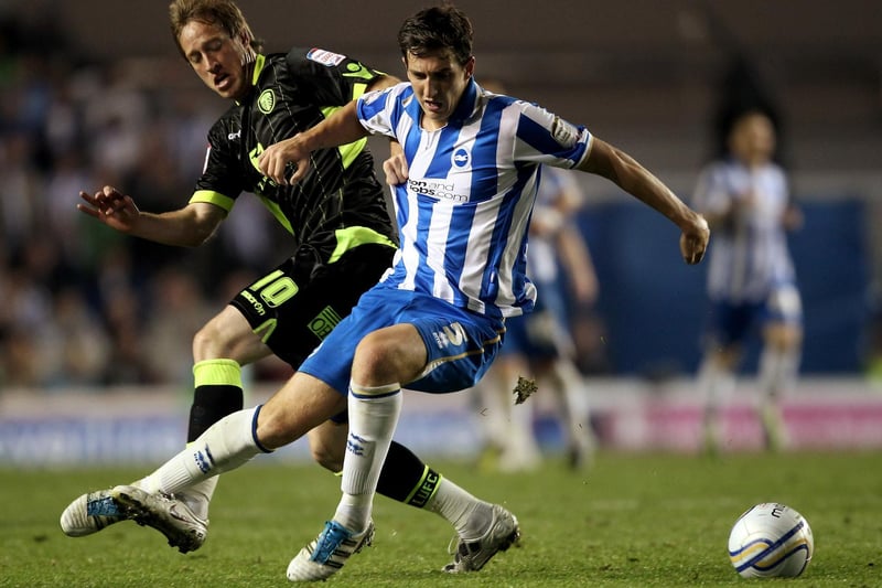 Striker Luciano Becchio and Brighton defender Lewis Dunk battle for the ball.