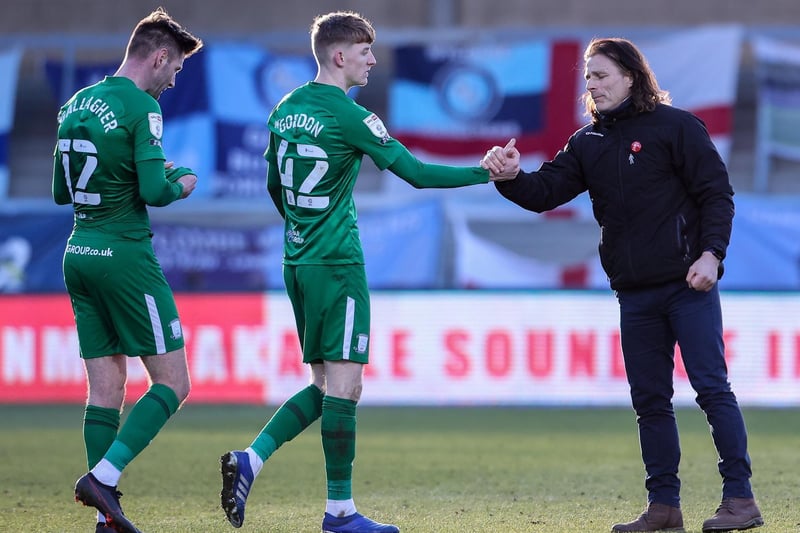 Wycombe manager Gareth Ainsworth gives a fist bump to PNE's Anthony Gordon