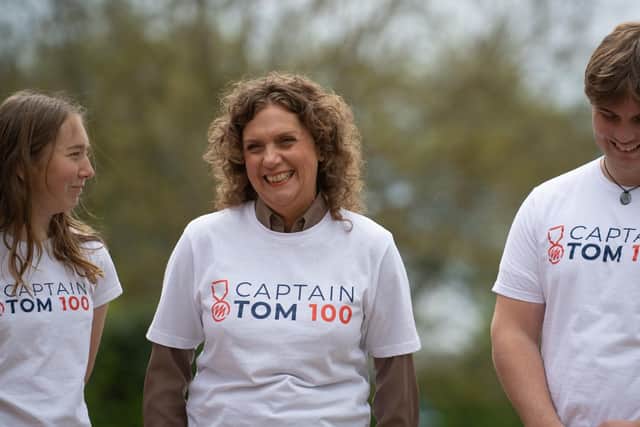 Captain Sir Tom Moore's daughter Hannah Ingram-Moore (centre) and his grandchildren Georgia and Benjie walk laps of their garden in Marston Moretaine, Bedfordshire, as they take part in the "Captain Tom 100" charity challenge.