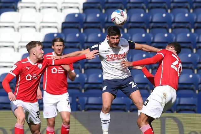 Preston North End striker Ched Evans challenges in the air against Barnsley at Deepdale
