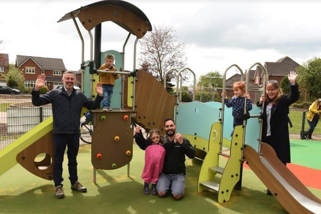 A dual slide is one of the new attractions at the revamped Bellis Way playground, a facility that Cllrs Matt Campbell (centre) and Damian Bretherton (left) have been campaigning for, along with local residents (image: Neil Cross)