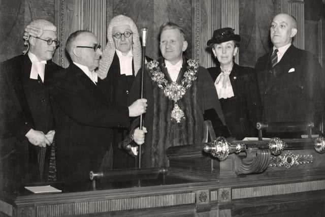 Outgoing Mayor Herbert Rhodes hands the staff of office to William Beckett in November, 1946. Also present are past mayor Alderman Margaret Pimblett and at far left, the Town Clerk, W Lockley