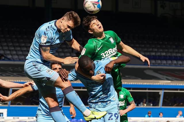 Preston North End defender Jordan Storey battles in the air against Coventry