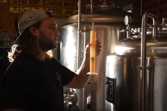 Ryan in his nano brewery, inside his garage