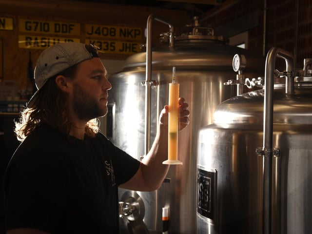 Ryan in his nano brewery, inside his garage