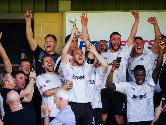 Matt Lawlor holds aloft the play-off final trophy after Brig won promotion from the NPL First Division North in 2018 (photo:Ruth Hornby)