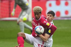 Preston North End defender Jordan Storey battles with Nottingham Forest striker Lyle Taylor