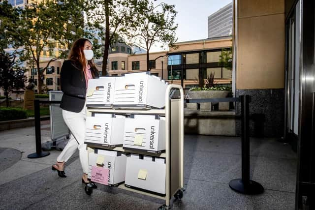 A member of the Epic Games legal team rolls a cart with documents while entering federal court on May 4, 2021 in Oakland, California.